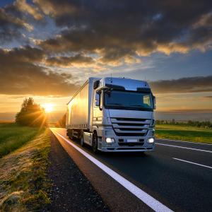 Truck at Dusk Countryside Two-lane, clouds and sun at the horizon AdobeStock_175552045.jpeg